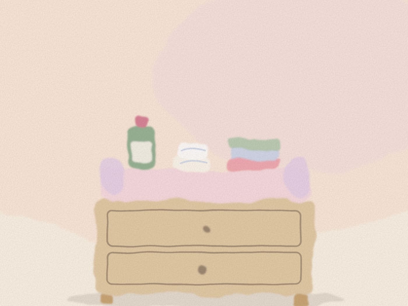 Matelas à langer avec couches, liniment et gants de toilette en coton, posés sur une commode simple