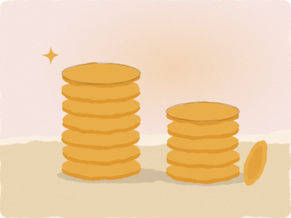 Deux piles de pièces dorées, une haute et une plus basse, comme les 70 % puis 60 % d'indemnisation